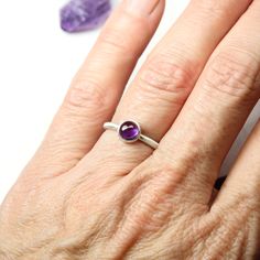 February's birthstone amethyst is such a popular color. This gorgeous deep dark orchid purple warms my heart. I decided to set this 6mm cabochon in a simple modern setting. A stackable silver ring with a trendy colored round gemstone dot in a circular bezel. Ring shank measures 1.9mm. **Made to order in your size (please allow 3-5 days) nangijalajewelry.etsy.com *Gemstone colors might vary slightly Classic Amethyst Cabochon Jewelry, Modern Purple Jewelry For Gifts, Modern Purple Jewelry As A Gift, Classic Purple Cabochon Jewelry, Spiritual Round Birthstone Gemstones, Spiritual Birthstone Gemstones, Classic Round Amethyst Birthstone Ring, Modern Oval Purple Jewelry, Modern Purple Oval Jewelry