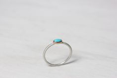 One tiny pale blue turquoise is set in a delicate rose gold bezel. A gorgeous color combination that reminds of the Southwest. Türkischen is a precious little ring design perfect for lovers of the dainty. I fabricated this ring from sterling silver and 14k rose gold. It is so sweet and pretty with a lovely popl of color. The turquoise cabochon measures 5x3mm. Ring width and thickness: 1.4mm Shown in size 6.25 * Made to order in your size (please allow 3-5 days) nangijalajewelry.etsy.com **Due to Dainty Turquoise Ring For Gift, Dainty Blue Turquoise Round Ring, Dainty Sterling Silver Turquoise Gemstone Ring, Dainty Hand-strung Turquoise Jewelry, Adjustable Nickel-free Silver Turquoise Ring, Turquoise Rose, Dainty Band, Turquoise Blue, Boho Rings