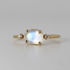 Fine Jewelry Oval Moonstone Ring With Rose Cut Diamonds, Fine Jewelry Yellow Gold Moonstone Ring, Heirloom Oval Moonstone Jewelry, 14k Gold White Moonstone Oval Cabochon Ring, Delicate Oval Moonstone Ring In 14k Gold, White Oval Cabochon Moonstone Ring In 14k Gold, Yellow Gold Oval Moonstone Ring, White Moonstone Oval Cabochon Ring In 14k Gold, Oval Moonstone Ring With Rose Cut Diamonds For Gift