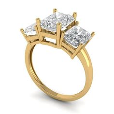 three stone engagement ring in yellow gold with princess cut diamonds on the sides and four prongs