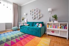 a living room with a blue couch and colorful rug