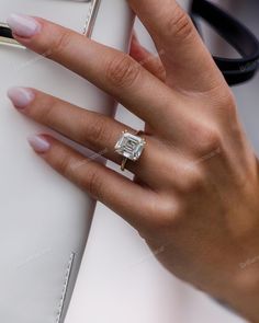 a woman's hand with a ring on her finger