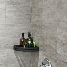 a bathroom sink with soap and lotion bottles on the shelf in front of it