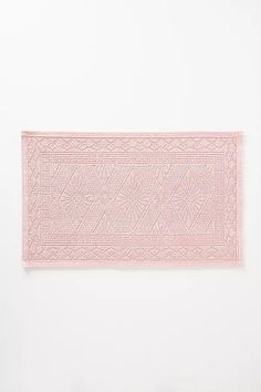 a pink rug is hanging on the wall