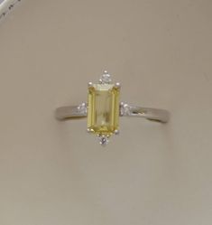 Yellow sapphire engagement ring. Promise ring. Emerald cut engagement ring. 5 stone ring. White gold engagement ring by Eidelprecious by EidelMini on Etsy https://www.etsy.com/listing/596798673/yellow-sapphire-engagement-ring-promise Sapphire Engagement Ring Silver, Yellow Sapphire Engagement Ring, Yellow Sapphire Ring Engagement, Yellow Sapphire Ring, 14k White Gold Diamond Ring, Yellow Sapphire Rings, White Gold Set, Emerald Engagement Ring Cut, Sapphire Engagement Ring Blue