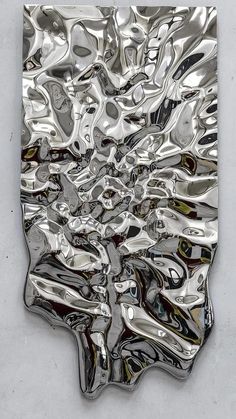 an abstract metal sculpture is shown on the wall