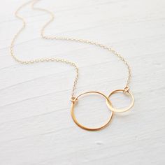 Modern classic, this necklace features two sterling silver interlocking circles that have been dipped in 24K gold for a rich gold color with a matte finish. They are linked into 14K goldfilled chain. . { m e a s u r e m e n t s } . Select length above. . { o p t i o n s } . Also available in sterling silver: https://www.etsy.com/listing/204002204/2-circle-necklace-two-circle-necklaces Also available in mixed metal: https://www.etsy.com/listing/176240048/mixed-metal-interlocking-circle-necklace . Linked Rings, Interlocking Circle Necklace, Jewelry Classic, Gold Circle Necklace, Gift For Best Friend, Linking Rings, Gold Circle, Circle Necklace, Rings Jewelry