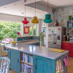 a kitchen with blue cabinets and colorful lights