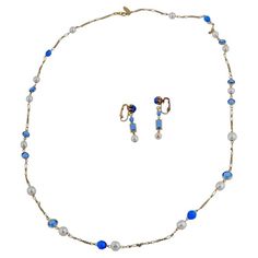 An American Miriam Haskell costume jewelry set. The set includes a necklace and a pair of earrings. The necklace is made of chain and decorated with pearls and blue glass stones. The earrings are made in the same design. Marked, Miriam Haskell, on a clasp. Miriam Haskell, 1899 to 1981, was an American designer of costume jewelry. With creative partner Frank Hess, she designed affordable pieces from 1920 through the 1960s. Her vintage items are eagerly collected and the namesake company, which fi Hotel In New York City, Dangle Bracelet, Costume Jewelry Sets, Mother Of Pearl Jewelry, Vintage Beads Necklace, Filigree Jewelry, Mabe Pearl, Pearl Jewelry Sets, Miriam Haskell