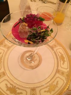 a glass bowl filled with food on top of a table