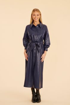 Wrap yourself in comfort and style with our Faux Leather Belted Maxi Dress, a sleek and stylish piece perfect for cooler days. This dress offers a chic buttoned front, ruched balloon sleeves for added volume and drama, and a belted waist to define your silhouette. Its faux leather material adds a layer of sophistication while keeping you cozy, making it an essential wardrobe choice for fall. Faux leather Maxi length Belted waist Long ruched balloon sleeves Available in Navy, Black Dry clean Styl Chic Fall Midi Dress With Puff Sleeves, Chic Puff Sleeve Midi Dress For Fall, Chic Collared Midi Dress For Fall, Fall Midi Dress With Buttons For Date Night, Fall Party Midi Dress With Button Closure, Fall Button-up Midi Dress With Covered Buttons, Fall Midi Dress With Button Closure For Date Night, Chic Long Sleeve Midi Dress With Covered Buttons, Fall Date Night Midi Dress With Button Closure