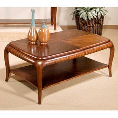 a wooden coffee table with two vases on the top and an end table underneath it