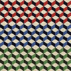 a close up view of a colorful knitted fabric pattern with different colors and shapes