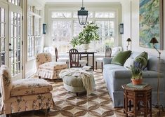 a living room filled with furniture and lots of windows