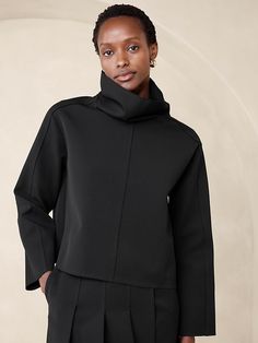 Modern Funnel Neck Top For Fall, Sleek Tops For Workwear With Minimal Stretch, Oversized Turtleneck Top For Work, Sleek Turtleneck Tops For Work, Modern Tops For Workwear, Sleek High Neck Top For Workwear, Structured Tops For Fall Workwear, Structured Tops For Work In Fall, Modern High Neck Tops For Workwear