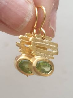 These are bright green peridot drop earrings. They have Bamboo stripes on top and oval gem under. The gem is bright green and it is August birthstone. They are delicate dangle earrings. Gold and green earrings. wedding earrings A 14 karat gold plated brass designer delicate handmade earrings, which has a minimalist romantic design. The earrings have an oval peridot gem, and bamboo design on top. All my gold plated earrings are made with a post made of 14K Goldfilled it is verydurable and safe to Bamboo Jewelry, Striped Earrings, Bamboo Earrings, Peridot Earrings, Street Swag, Gold And Green, August Birthstone, Romantic Design, Earrings Green