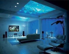 a living room filled with furniture and a flat screen tv mounted to the ceiling above it