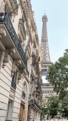 the eiffel tower towering over the city of paris, france as seen from an alleyway