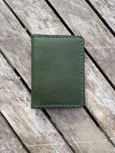 "- 100% full grain vegetable tanned leather (except for thread) from the Badalassi Carlo Tannery in Tuscany, Italy. - Leather is medium temper. - Wallet exterior (main panel) is an Emerald GREEN with a pebbled finish. - Interior leather pockets are SADDLE TAN BROWN with a smooth finish from the same Italian tannery. - DARK GREEN leather edge sealant applied. - Dimensions when closed; nominally 3\"x4\" - readily fits in most front pockets. Easily fits in pants pocket, purse, etc. - 4 card slots. Will accept more than 4 cards as well as folded cash - Wallet pieces are hand-cut and hand stitched together. Hand stitching takes longer but is a more durable assembly. - This leather has Limited Availability. - This Vegetable Tanned Leather comes from the Badalassi Carlo Tannery in Tuscany, Italy. Hand-stitched Leather Card Holder For Everyday Use, Leather Card Holder With Waxed Finish, Vegetable-tanned Trifold Wallet For Everyday Use, Vegetable-tanned Trifold Wallet For Daily Use, Daily Use Vegetable-tanned Trifold Wallet, Everyday Vegetable-tanned Trifold Wallet, Leather Card Holder With Waxed Finish For Everyday Use, Everyday Leather Card Holder With Waxed Finish, Vegetable-tanned Leather Wallet For Daily Use