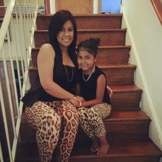 a mother and daughter sitting on the stairs