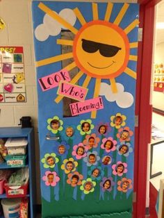 a classroom door decorated with the sun and flowers