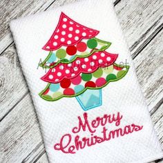 a christmas tree appliqued on a white towel with polka dots and the words merry christmas