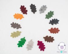 several different colors of felt leaves arranged in a circle