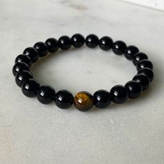 The beauty and wonder of the tiger eye bead culminate with a black onyx beaded bracelet. This is the perfect accessory for those who wish to evoke fearlessness, strength, and daring. The symbolism that these beads bear will ensure love and harmony no matter where you go. Wear this as your protection charm! The tiger eye bead is considered a power stone that can keep bad energy away. Black onyx beads are thought to promote emotional balance, which is why they've specially matched with the Tiger E