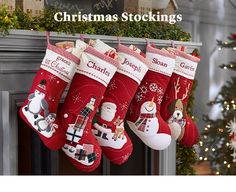 christmas stockings hanging from a mantel decorated with snowmen and santa claus's stocking