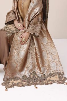 Luxury Bronze Shade Embroidered Pakistani Salwar Kameez Dupatta Suit Crafted with intricate dori work and hand-worked with a delicate tapestry of stones. Gold Jamawar Anarkali Set With Intricate Embroidery, Traditional Gold Jamawar Dress, Gold Traditional Wear With Intricate Embroidery In Jamawar, Intricate Embroidery Jamawar Anarkali Set For Eid, Elegant Unstitched Anarkali Set For Traditional Ceremonies, Gold Jamawar Dress With Resham Embroidery, Gold Jamawar Dress With Zari Work, Eid Anarkali Set With Intricate Embroidery In Jamawar, Gold Jamawar Set With Intricate Embroidery