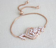 There’s nothing like a bracelet to incorporate in your wedding look and make that wedding ring pop even more! This pretty rose gold cubic zirconia bridal bracelet is adjustable and it will complement elegant looks like nothing else! The unique design and the way in which it flawlessly incorporates both CZ and rose gold will charm you in an instant!Created with an adjustable slide chain to fit most wrist sizes.- Created with Premium cubic zirconia stones - Rose gold plated over brass, nickel free Gold Bracelet Indian, Art Deco Bridesmaids, Bridal Bracelets, Gold Bridal Necklace, Rose Gold Pendant Necklace, Slide Bracelet, Rose Gold Bridal, Jewelry Bracelets Gold, Bridal Fashion Jewelry