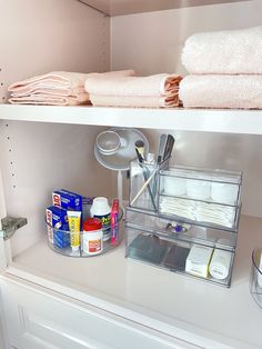 the shelves in this bathroom are filled with toiletries and other items, including towels