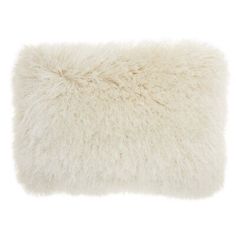 a white furry pillow on a white background