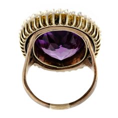 Absolutely beautiful antique impressive size amethyst pearl and 14kt yellow gold ring centrally set with one large oval shaped faceted deep vibrant purple amethyst measuring approximately 19 x 14 x 9.5mm depth with an approximate weight of 13.40 cts. surrounded by a gold wirework filigree intricate frame further accented with numerous small peg set pearls - substantial 14kt yellow gold ring mount - very good condition - hard to approximate size but somewhere around a size 7.5 - 8 can be sized - Fine Jewelry Purple Amethyst Cabochon Ring, Purple Amethyst Cabochon Ring Fine Jewelry, Victorian Oval Pearl Ring With Gemstone, Amethyst Cabochon Ring For Wedding, Cabochon Amethyst Ring For Wedding, Victorian Oval Amethyst Ring With 17 Jewels, Oval Purple Amethyst Ring With 17 Jewels, Oval Cabochon Amethyst Heirloom Ring, Heirloom Oval Cabochon Amethyst Ring