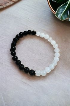 "Handmade using Natural White Jade and Black Onyx Gemstones A simple elegant bracelet that will stand on its own, or bring a touch of elegance to other accessories. White jade is known to symbolize peace and harmony. Black onyx helps to promote strength, focus and protection. Feel grounded and clear thinking. Bracelet Size: 8.5\"/21.4 cm Bead Size 8 mm Bracelets stretch to fit most sizes Bracelet is strung with strong elastic cord for jewelry. Do not pull, tug or yank stretch bracelet up and over your hand.   This will result in a broken bracelet and/or stretched out cord. Roll bracelets on or off individually when putting on or removing. *Please do not leave within reach of small children* Made in a pet and smoke free environment. Ready to Ship ** Free Shipping *LISTING IS FOR ONE BRACELE Men's Beaded Bracelets Handmade, Etsy Beaded Bracelets, Men Beaded Bracelet, Aesthetic Bracelets, Buddhism Wallpaper, Beaded Bracelet For Men, Small Bead Bracelet, Boys Bracelets, White Beads Bracelet