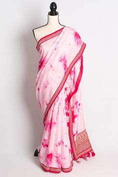 Discover the epitome of elegance with our Dola Silk Shibori Designer Saree with Zardosi Border in Pink, exclusively from Bengal Looms. This exquisite saree marries traditional craftsmanship with contemporary style, featuring intricate Zardosi embroidery along its rich Dola Silk fabric. Perfect for any special occasion, its stunning Shibori design adds a unique, artistic flair. Experience the convenience of free, fast shipping from within the USA and elevate your wardrobe with this luxurious piec Unstitched Bandhani Print Pre-draped Saree For Weddings, Fitted Sharara With Dori Work For Puja, Silk Bandhani Print Traditional Wear For Wedding, Wedding Bandhani Print Traditional Wear In Georgette, Wedding Traditional Wear With Bandhani Print In Georgette, Pink Art Silk Blouse With Bandhani Print, Pink Traditional Wear With Bandhani Print In Dola Silk, Party Wear Bandhani Print Georgette Saree, Unstitched Bandhani Blouse Piece For Wedding