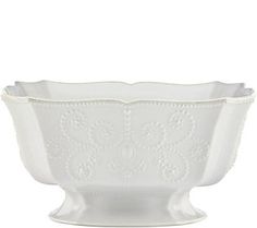 a white bowl with an ornate design on the rim and bottom, sitting in front of a white background