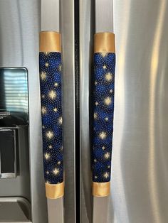 two blue and gold stars are on the side of a stainless steel refrigerator with its door open