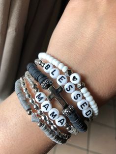 *This stack can be personalized to say any name/saying that you would like.* PLEASE ONLY ONE(1) CROSS BRACELET PER SET!! **PLEASE ONLY ONE(1) GRAY HEART BRACELET PER SET **Bracelets can be purchased single or in sets of 2,3,4,5 or all 6(as pictured).** *Will make a perfect Mother's Day gift for mama ,grandma or even Aunt!* *Please roll on bracelet rather than stretch on to prevent breaking.* *Please measure wrist before ordering.* **All sales are final as these are custom bracelets.** Auntie Bracelet, Jewelry Booth, Heishi Bracelets, Stacked Beaded Bracelets, Gray Heart, Kandi Inspo, Homemade Bracelets, Stack Bracelet, Friendship Bracelets With Beads