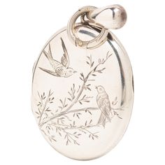 Antique Victorian silver photo locket with a typical for Aesthetic movement design. The front of this beautiful piece depicts a pair of swallow birds, one in a flight and another one sitting on the branch. The swallow was very popular in the Victorian era and the jewellery with this bird motif was often given to loved ones when they set out on a journey to keep them safe. The swallow is also a symbol of love and devotion. This is a typical aesthetic movement motif, and this locket is a lovely ex Swallow Birds, Movement Design, Victorian Aesthetic, Sterling Silver Locket, Silver Locket, Jewelry Lockets, Bird Motif, Aesthetic Movement, Swallows