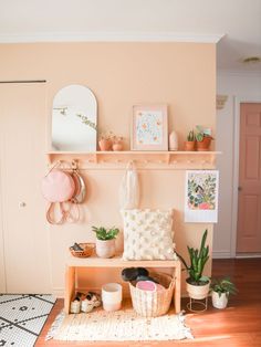 a living room filled with lots of furniture and decor on top of a wooden shelf