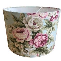 a lamp shade with pink and white flowers on it