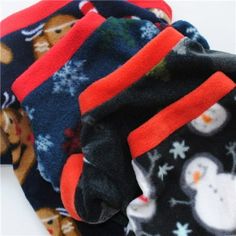 three pairs of socks with snowmen and bears on them, all in different colors