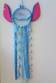 a blue dream catcher hanging on the wall