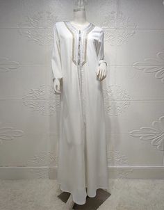 SPECIFICATIONS Elevate your style with our Polyester Abaya adorned with intricate embroidery. Perfect for various occasions, this piece combines comfort and sophistication effortlessly. Order now to embrace a timeless and fashionable look. Processing Time : 20-25 Business Days Department Name: Adult. Material: High-quality Polyester for comfort and durability. Decoration: Exquisite Embroidery, adding a touch of elegance. Item Type: Abaya, a versatile and stylish addition to your wardrobe. Elegant White Long Sleeve Agbada, Modest Long White Thobe, White Floor-length Abaya, Elegant Dabka Thobe For Eid, Elegant White Long Sleeve Abaya, Elegant Long White Abaya, Elegant Long Sleeve Wedding Thobe, White Long Sleeve Agbada For Eid, White Long Sleeve Thobe For Eid