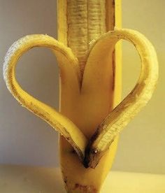 there is a banana that has been cut in the shape of a heart and words written on it