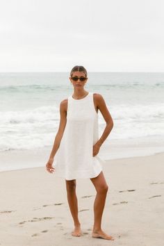 Elevate your wardrobe with the Toulouse Linen Mini Baby Doll. This classic high neck tank dress, made from linen, offers an elevated, timeless look. Luxuriously soft and breathable, this babydoll dress will keep you comfortable and chic. Sleeveless Linen Mini Dress For Daywear, White Linen Mini Dress For Daywear, White Linen Mini Dress For The Beach, White Linen Sleeveless Dress For Beach, White Linen Mini Dress For Vacation, White Sleeveless Linen Dress For Day Out, Sleeveless Linen Mini Dress For The Beach, White Linen Sleeveless Dress For Daywear, White Linen Mini Dress For Day Out