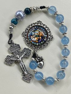 Pocket Rosary blue rosary Holy Family Centerpiece Christmas Rosary, Catholic woman, Catholic gift, Catholic mom gift, handmade rosary    Catholic gift, Catholic mom, Catholic gift, catholic gift for her, Catholic mom, RCIA, Confirmation gift, weddings These one of a kind handmade rosaries are beautiful and would make a wonderful Reconciliation or Confirmation gift! Also great for wedding gift or RCIA gift! The colors are gorgeous!  The antique bronze crucifix and Medal are beautifully detailed. Mother's Day Gift Rosary With 8mm Beads, Handmade Blue Crucifix Jewelry, Spiritual Beaded Rosary As Gift, Spiritual Blue Jewelry For Mother's Day, Blue Beaded Jewelry For Mother's Day, Blue Rosary With Round Beads For Gift, Blue Rosary Bracelet For Jewelry Making, Gift Rosary With 8mm Round Beads, Rosary With 8mm Round Beads As Gift