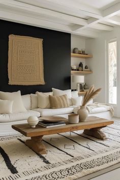 a living room with black walls and white furniture in the center, along with an area rug on the floor