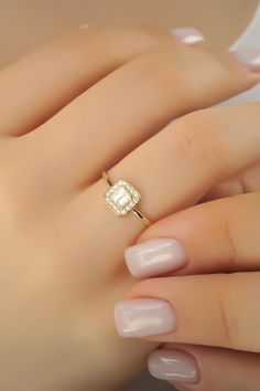 a woman's hand with a diamond ring on it